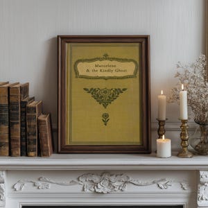 May include: A framed print with a yellow background and green text that reads "Marcelene & the Kindly Ghost". The print is surrounded by a dark brown frame and is displayed on a white mantel with two candlesticks and candles.