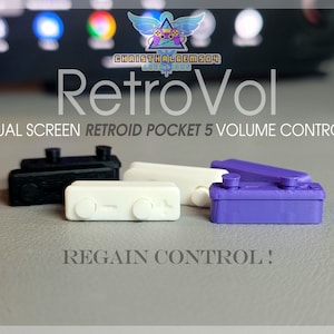 May include: RetroVol dual screen Retroid Pocket 5 volume control accessories in black, white, and purple. The accessories have a rectangular shape with rounded edges and buttons. The text "Regain Control!" is visible.
