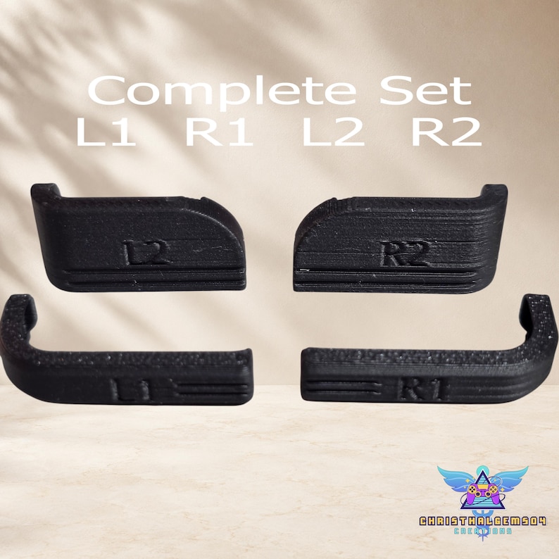 May include: A complete set of four black controller shoulder buttons labeled L1, R1, L2, and R2. The text Complete Set L1 R1 L2 R2 is visible above the buttons. Each button features a textured surface and specific ergonomic curves for gaming.