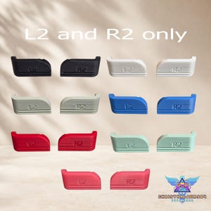May include: A collection of L2 and R2 controller trigger extenders in black, white, gray, blue, red, light green, and pink. Each piece features embossed L2 or R2 text. The image includes the text L2 and R2 only at the top and a logo at the bottom.