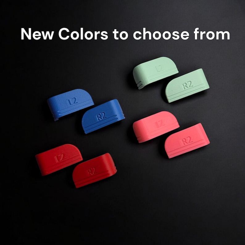 May include: Four pairs of L2 and R2 controller trigger button covers in light green, blue, pink, and red. Each button cover features embossed L2 or R2 text and horizontal line detailing. The text New Colors to choose from is displayed above.