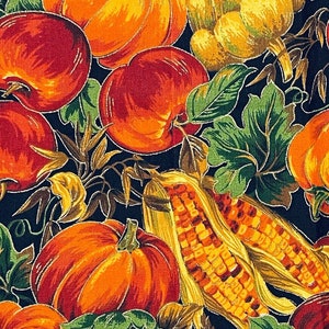 May include: A fabric design featuring a harvest theme. The pattern includes pumpkins, apples, corn, and squash in orange, red, yellow, and green hues set against a dark backdrop. The material is likely cotton or a similar textile.