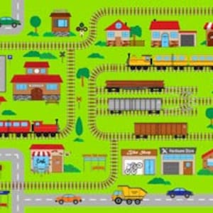 May include: A colorful, illustrated play mat featuring a town with buildings, roads, trees, and a train track. The mat includes a red and yellow train, cars, and various shops and houses. The background is green.