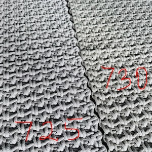 May include: Two sections of light gray woven fabric featuring a dense, textured grid pattern. The left section is marked with the red handwritten number 725, and the right section is marked with the red handwritten number 730, indicating distinct variations.