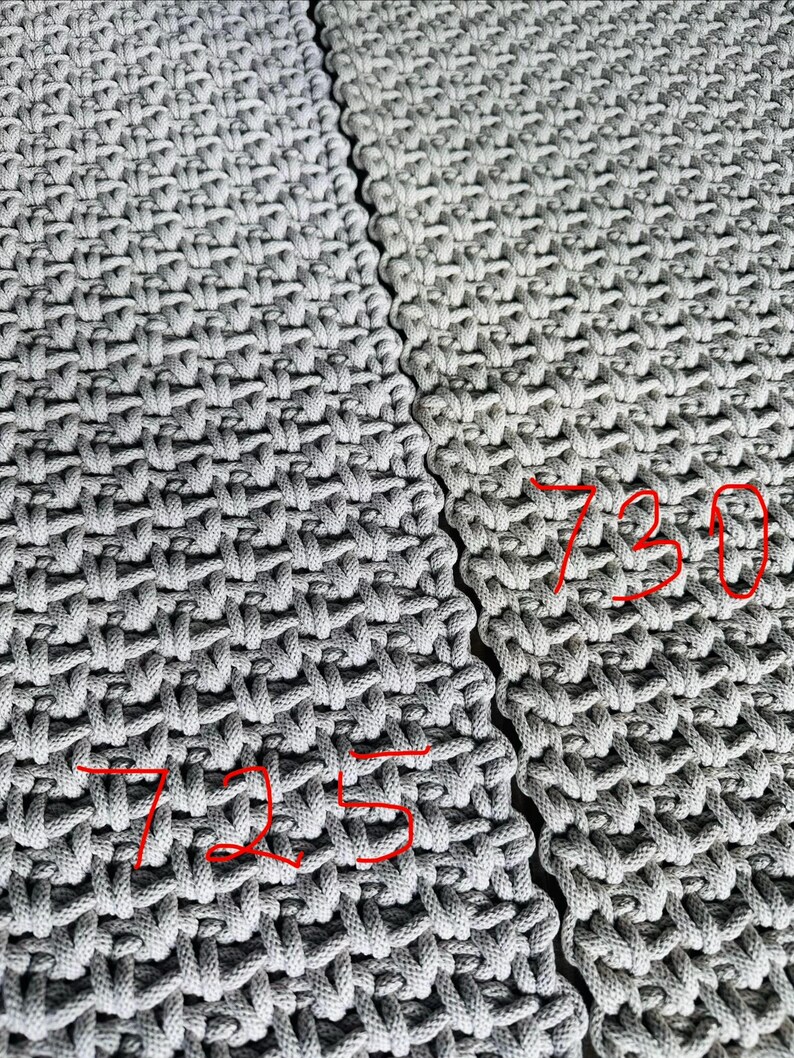 May include: Two sections of light gray woven fabric featuring a dense, textured grid pattern. The left section is marked with the red handwritten number 725, and the right section is marked with the red handwritten number 730, indicating distinct variations.