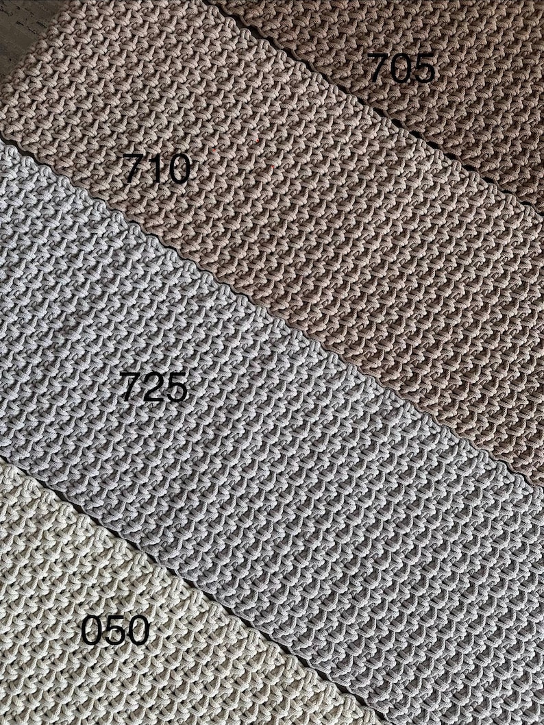 May include: Four strips of woven cord fabric arranged diagonally. The colors are dark brown, medium brown, light gray, and off-white. Each strip is labeled with a black number: 705, 710, 725, and 050, indicating the specific color variant.