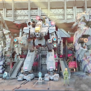 May include: Three large, gray, and white, robot-like figures stand in a hangar-like setting. The figures are made of plastic and have a futuristic design. The figures are posed in a battle-ready stance.