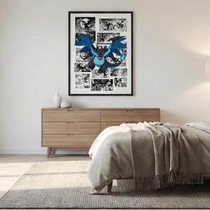 May include: A framed poster featuring a black and blue dragon illustration with comic book style panels in the background. The dragon has large blue wings and a blue flame. The poster is displayed above a wooden dresser in a bedroom.