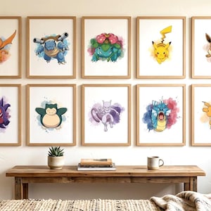 May include: A collection of ten framed wall art prints featuring watercolor-style illustrations of various creatures, including Charizard, Blastoise, Venusaur, Pikachu, Eevee, Gengar, Snorlax, Mewtwo, Gyarados, and Dragonite, arranged in two rows.