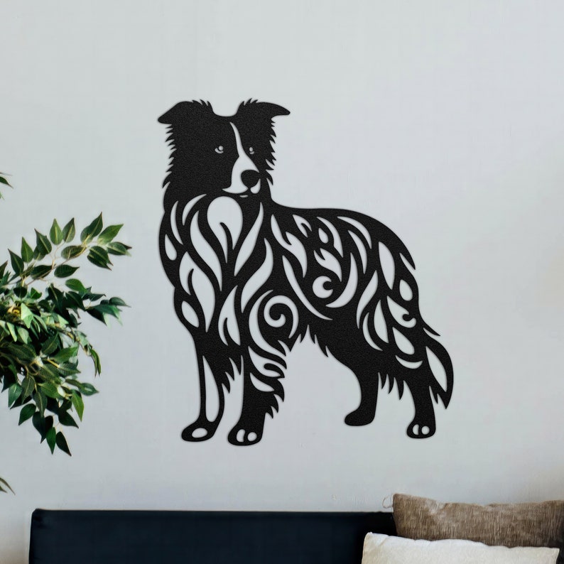 May include: Black silhouette of a border collie dog with intricate floral patterns cut out of the shape. The dog is standing with its head turned slightly to the side.