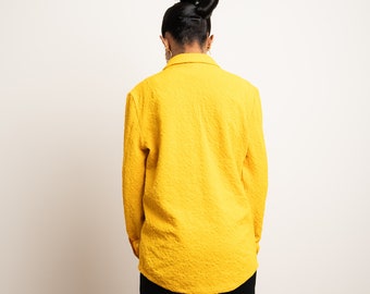 Muestra de blusa túnica con jacquard floral: Top con bolsillo de parche