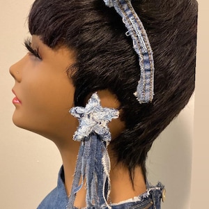 May include: A denim star-shaped hair clip with frayed edges and a blue denim headband with the text "#denmovethedepression" on it.