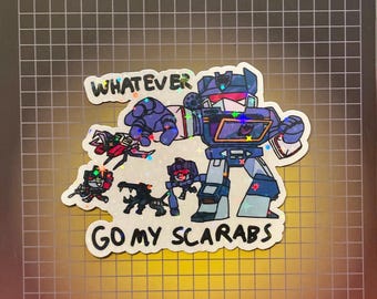 Puede incluir: Una pegatina holográfica con robots de dibujos animados y el texto "WHATEVER GO MY SCARABS". El robot principal es azul y morado, con robots más pequeños en rojo, negro y morado. Fondo cuadriculado.