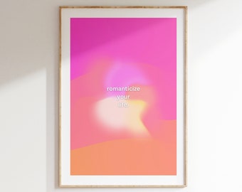 May include: A framed print with a pink and orange gradient background. The text "romanticize your life." is in white on the print.