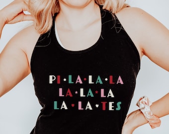 May include: Black tank top with the text "PI • LA • LA • LA LA • LA • TES" in colourful letters. The tank top is sleeveless and has a racerback design. The word "BLACK" is printed at the bottom right.