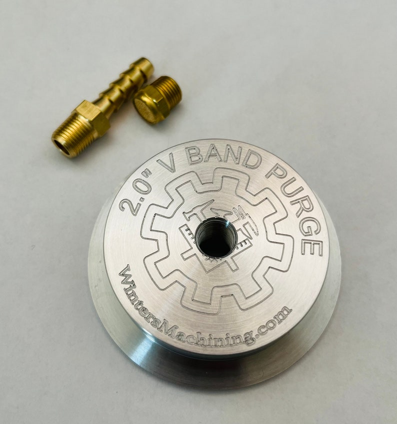 May include: A silver 2.0" V-Band Purge with a gear-like design and the text "WintersMachining.com". The purge is accompanied by two brass fittings.