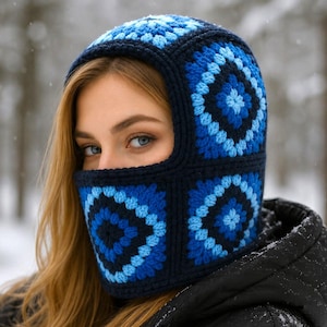 May include: A blue and navy crocheted balaclava with a geometric pattern. The balaclava covers the head and neck, with an opening for the eyes and part of the face. The text "Pattern in 4 Languages" is visible at the bottom of the image.