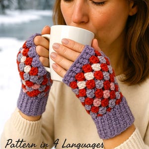May include: A person wearing crocheted fingerless gloves, holding a white mug. The gloves are purple, red, pink, and white. The text "Pattern in 4 Languages" is at the bottom of the image. The background is a snowy outdoor scene.