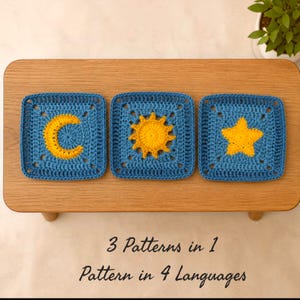 May include: Three square crochet motifs featuring blue backgrounds with yellow yarn appliques of a crescent moon, a sun, and a five-pointed star. The text below reads 3 Patterns in 1, Pattern in 4 Languages. The items are arranged on a wooden surface.