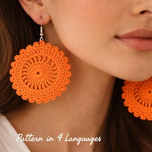 May include: Bright orange, crocheted earrings with a circular design and a scalloped edge. The earrings are shown on a person. The text "Pattern in 4 Languages" is at the bottom of the image.