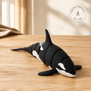 May include: A black and white articulated orca figurine with a segmented body design. The figure features a dorsal fin, side fins, and a tail. A circular badge in the upper right corner displays the text Digital Download, STL + 3MF.