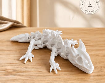 May include: A white 3D printed articulated lizard figurine with a skeletal structure. The circular badge in the upper right corner features a downward arrow icon and the text DIGITAL DOWNLOAD, STL + 3MF.