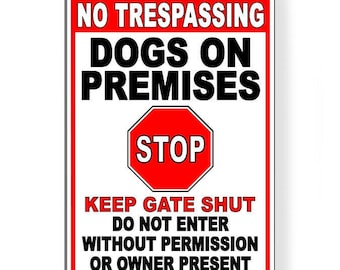 May include: Red and white sign with the text "NO TRESPASSING DOGS ON PREMISES STOP KEEP GATE SHUT DO NOT ENTER WITHOUT PERMISSION OR OWNER PRESENT".