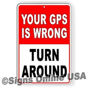 May include: Red and white metal sign with the text "Your GPS is wrong Turn Around" in black lettering. The sign has a hole at the top for hanging.