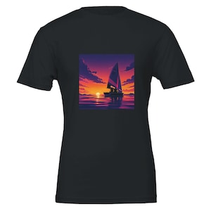 May include: Black t-shirt featuring a square graphic of a sailboat on the water at sunset. The image shows a sailboat with a purple sail, silhouetted figures, and a vibrant orange and purple sky reflected in the water.