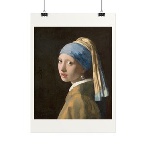 May include: A portrait of a person wearing a blue headscarf and a yellow garment, featuring a large white pearl earring. The subject is positioned against a dark background, looking over their shoulder with a neutral expression.