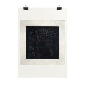 May include: A rectangular wall art print featuring a central black square with a visible network of fine white cracks across its surface, set against a solid off-white border, suspended by two black metal clips at the top edge.