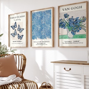 May include: Three framed art prints with blue and white designs. The prints are titled "Pablo Picasso", "William Morris", and "Van Gogh". The prints are hanging on a white wall.