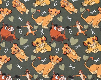 May include: A green fabric with a repeating pattern of cartoon lions, warthogs, and meerkats. The characters are all smiling and have hearts and Xs around them.