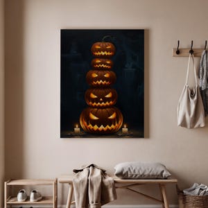 May include: A Halloween-themed canvas print featuring a stack of five carved pumpkins with glowing orange eyes and mouths. Two lit candles flank the base of the pumpkin tower. The background is dark with a hint of a spooky scene.