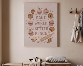 以下が含まれることがあります： ベーキングをテーマにしたキャンバスプリント。アートワークは、テキスト「Bake the World a Better Place」を囲むように、カップケーキ、クッキー、めん棒が描かれています。カラーパレットは、茶色、ピンク、白の色合いを含んでいます。