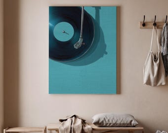 May include: A dark blue vinyl record on a teal canvas, with a silver tone needle arm. The record reflects light. The canvas is mounted on a wall in a room with a bench, shoes, and a coat rack.
