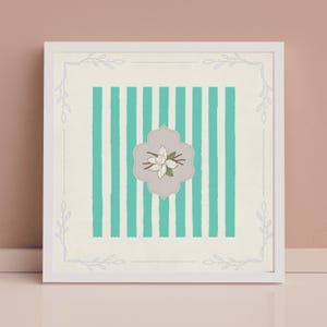 May include: A white framed print with a teal and white striped background and a white flower with green stems in a gray oval. The frame has a decorative border of gray branches.