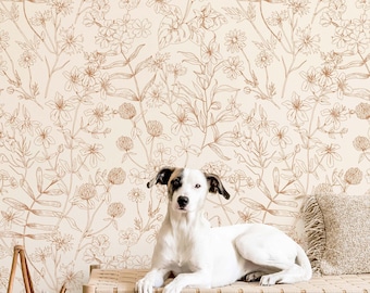 May include: Wallpaper featuring a repeating line art pattern of wildflowers and clover in a warm brown tone against a cream background. The design includes various stems, leaves, and blossoms arranged in a dense, botanical illustration style.