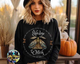 May include: Black sweatshirt with a graphic of a moth and the text "Hedge Witch" in a circle. The text reads "A Hedge Witch lives amongst the trees with slimy snails and herbal teas. She plays all day with forest friends and hoards the strangest odds and ends."