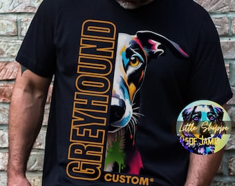 May include: A black t-shirt with an orange graphic of a greyhound dog's head. The text "Greyhound" is written vertically in orange on the left side of the graphic. The text "CUSTOM*" is written in orange below the graphic.