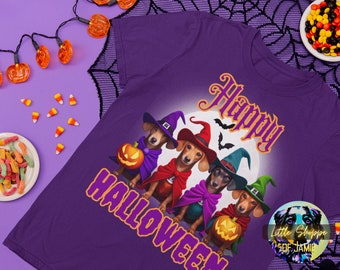 May include: Purple t-shirt with a Halloween theme featuring four dachshunds dressed in witch costumes. The text "Happy Halloween" is printed on the shirt.