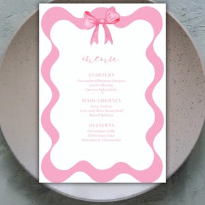 May include: A pink menu with a pink bow at the top. The menu lists starters, main courses, and desserts. The text on the menu reads: "menu", "STARTERS", "Cucumber&Salmon canapes", "Garlic Shrimp", "Festive baked Brie", "MAIN COURSES", "Juicy Turkey", "Low-and-Slow Roast beef", "Baked Salmon", "DESSERTS", "Christmas Trifle", "Christmas Cake", "Strawberry Cheesecake".
