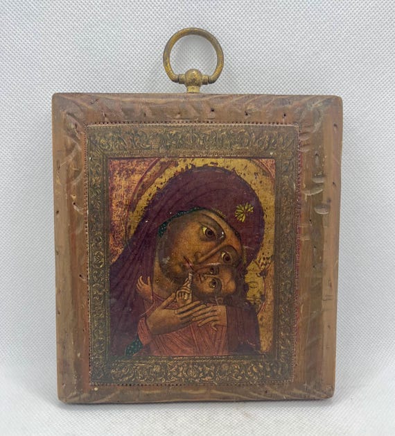 Vintage religious wooden icon Virgin Mary and the Christ Child in embrace , Christian Art