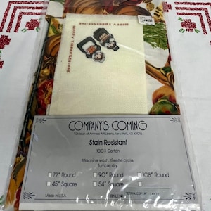 May include: A packaged tablecloth with a colorful cornucopia design, featuring pumpkins, gourds, and other harvest elements. Includes a cross-stitch project with two figures and the text "HAPPY THANKSGIVING". The package also includes a label with size options.