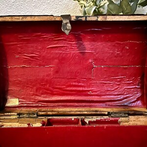 May include: An antique wooden box with a red velvet lining. The box has a brass latch and hinges. The inside of the box is divided into compartments.