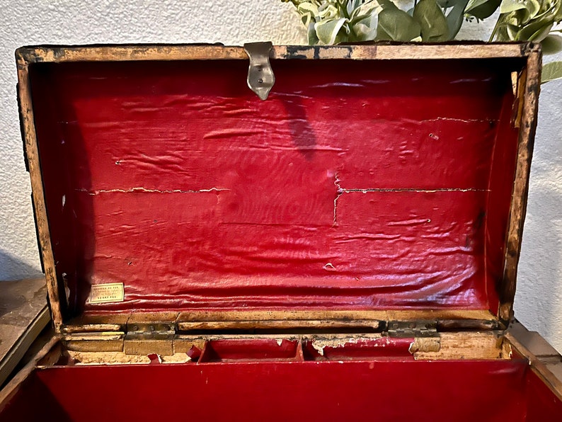 May include: An antique wooden box with a red velvet lining. The box has a brass latch and hinges. The inside of the box is divided into compartments.