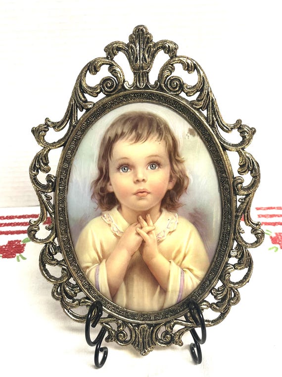 Vintage art print of a praying child in ornate baroque style cast metal frame with convex glass