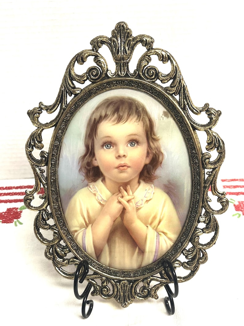 Vintage art print of a praying child in ornate baroque style cast metal frame with convex glass, vintage wall art
