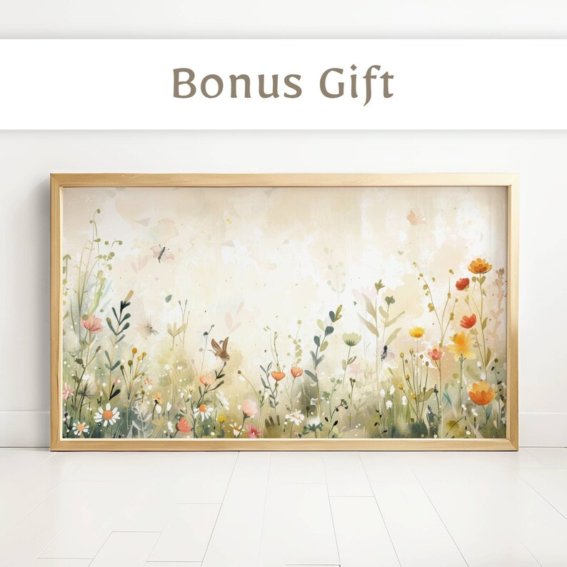 May include: A framed watercolor painting of a field of wildflowers with butterflies. The painting is in a light wood frame and has a soft, dreamy feel.