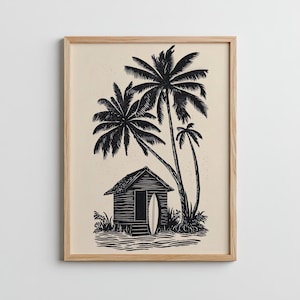 Könnte beinhalten: Schwarz-Weiß-Druck einer tropischen Szene mit einer kleinen Holzhütte, Palmen und einem Surfbrett. Das Kunstwerk ist in einem hellen Holzrahmen gerahmt und erzeugt ein Küstenmotiv.